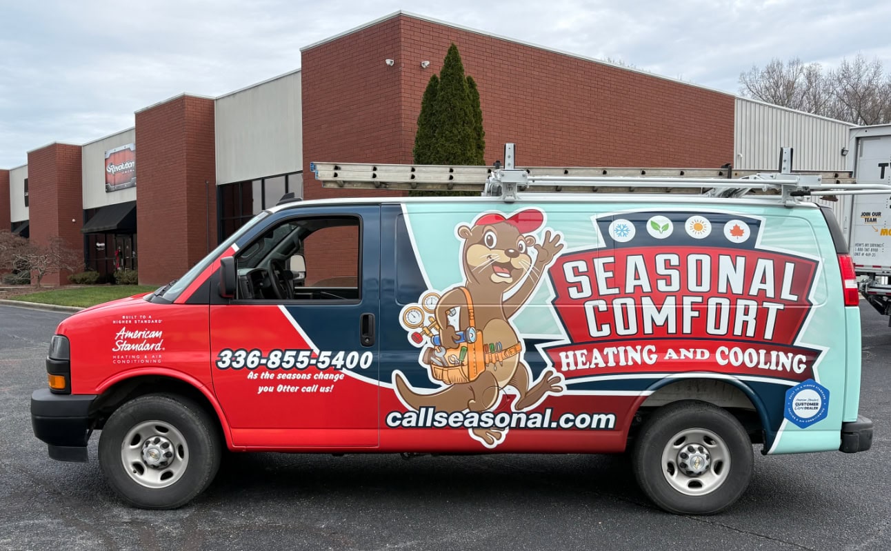 Seasonal Comfort Heating and Cooling service van outside company office in Greensboro, NC.